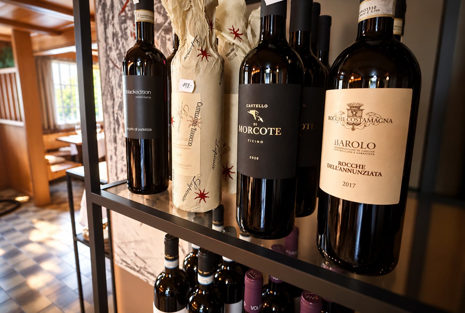 Flaschen Barolo und weitere italienische Rotweine im Weinregal